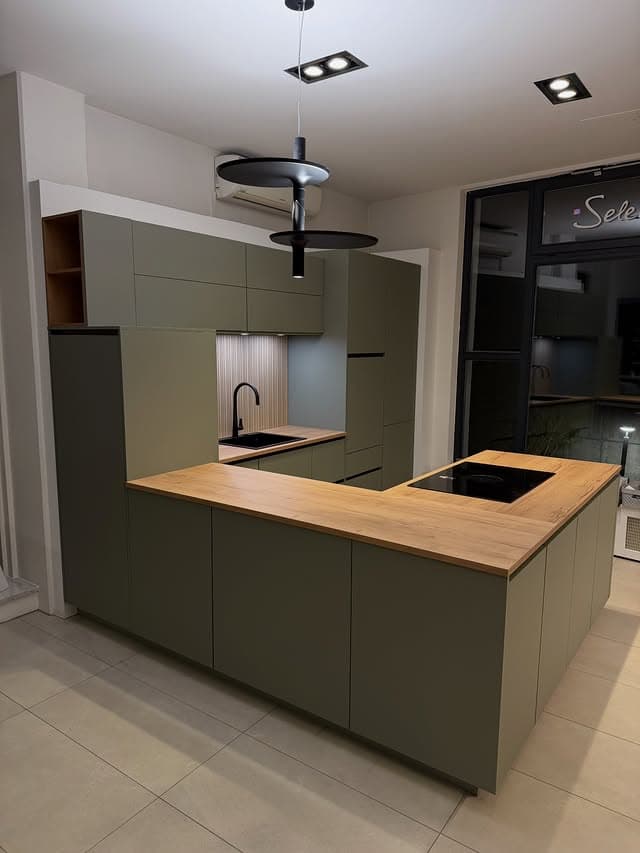 Moderne Nobilia-Küche mit grünen Fronten und Designleuchte